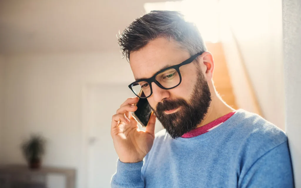 A man calling Mold Dog Network on his phone