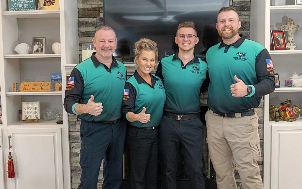 The mold dog network team giving the camera a thumbs up