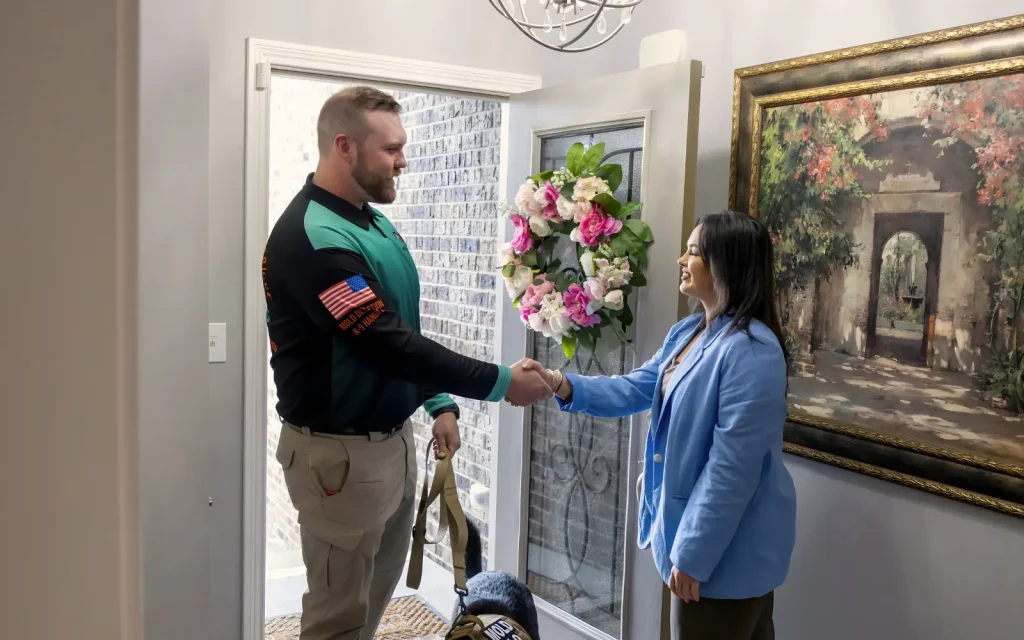 A member of the Mold Dog Network team being welcomed into a home during a residential mold inspection