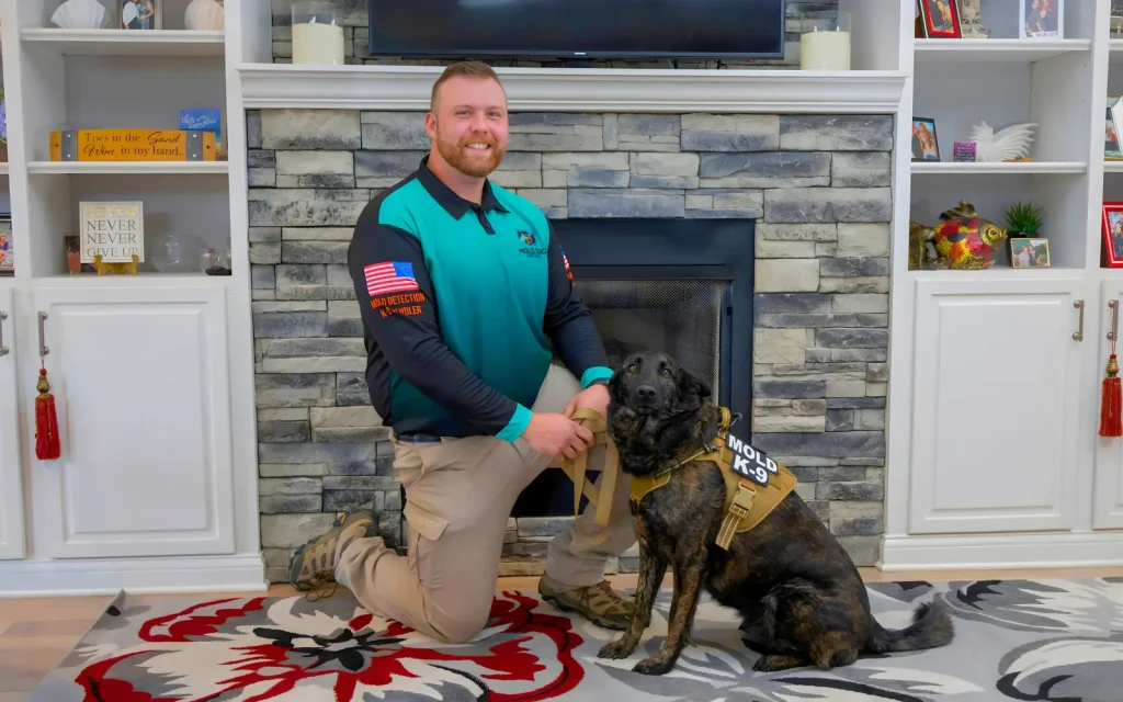 A mold dog and handler in a residential home